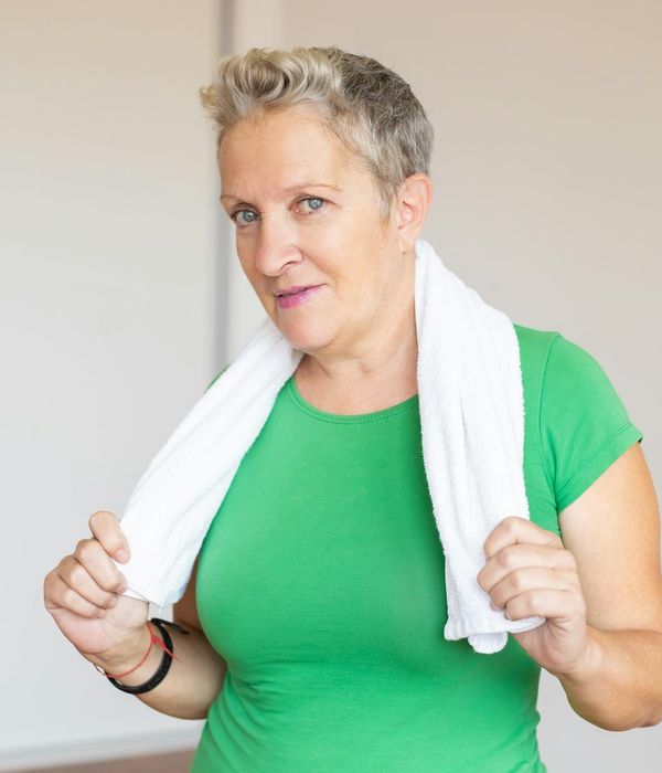 Woman feeling energetic and happy after a light workout in her living room.